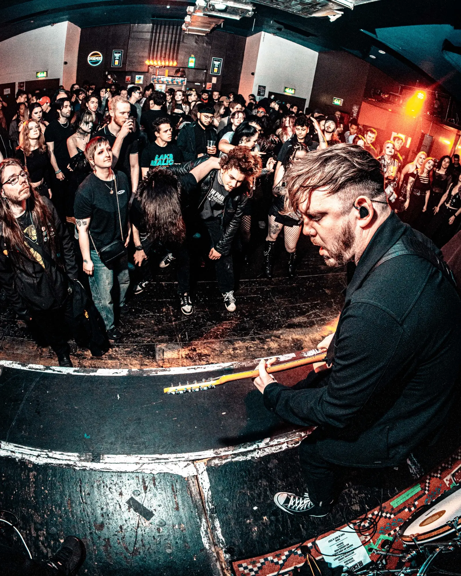 Live guitar performance facing a crowd